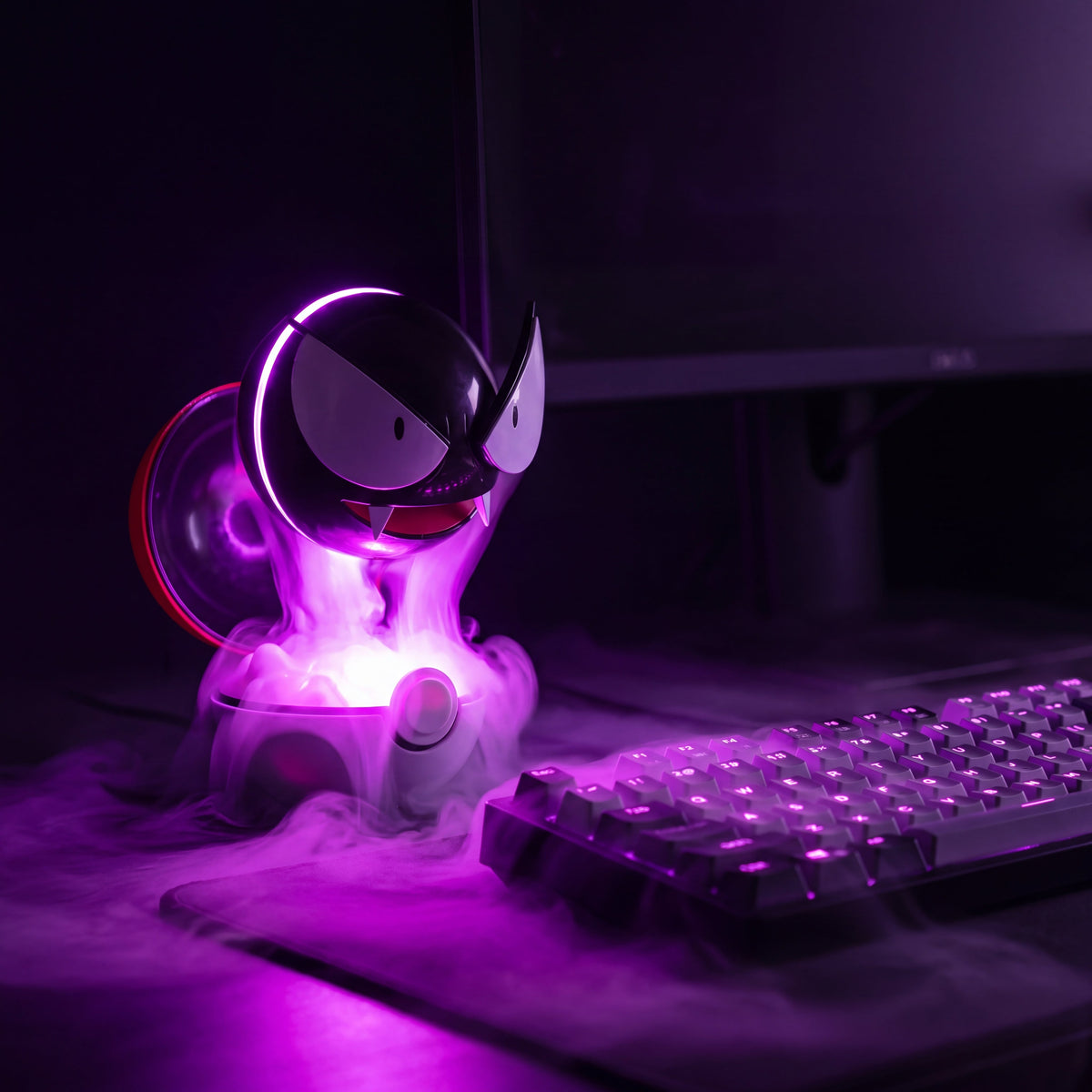 Ghost Orb mist lamp glowing magenta on a gaming desk at night